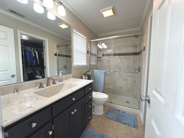 bathroom featuring a stall shower, tile patterned floors, vanity, a spacious closet, and toilet