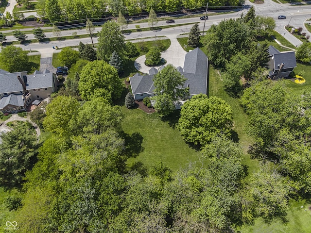aerial view of property's location featuring a tree filled landscape