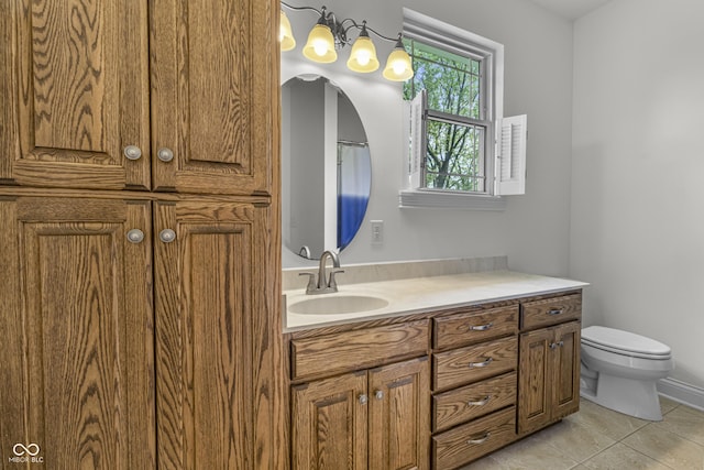 bathroom with toilet, tile patterned flooring, and vanity