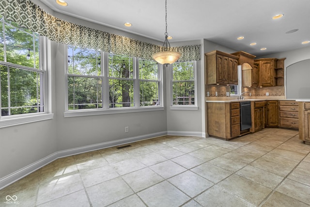 kitchen with dishwasher, light countertops, tasteful backsplash, baseboards, and recessed lighting