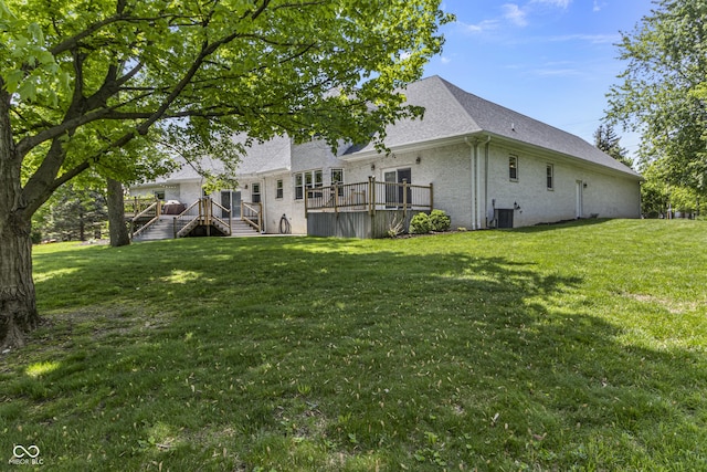 view of grassy yard featuring a wooden deck, stairs, and cooling unit