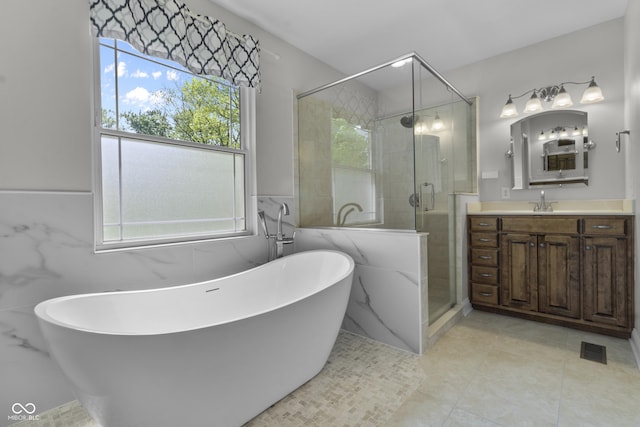 full bathroom with a stall shower, vanity, a soaking tub, and a wainscoted wall