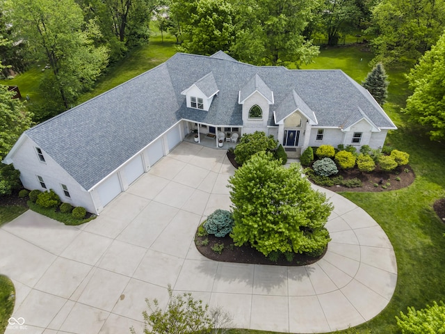 aerial view of property and surrounding area with a tree filled landscape