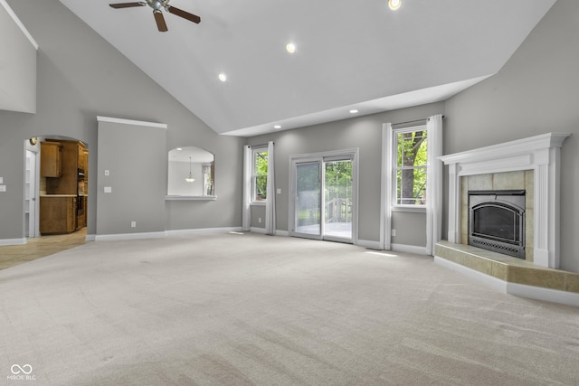 unfurnished living room with carpet flooring, ceiling fan, a tile fireplace, recessed lighting, and baseboards