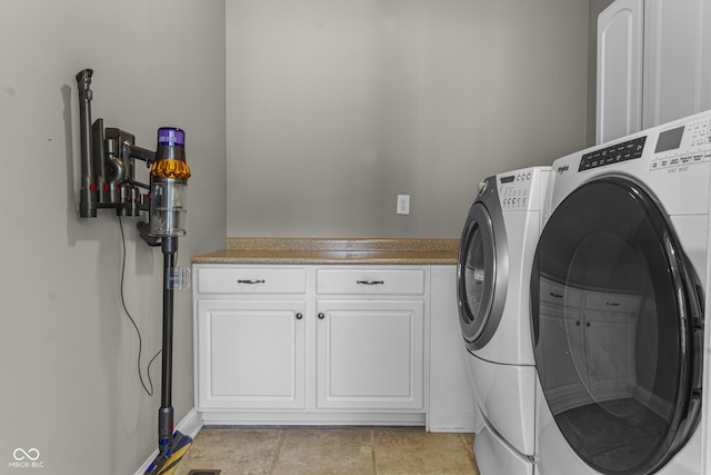 laundry room featuring washer and clothes dryer and cabinet space