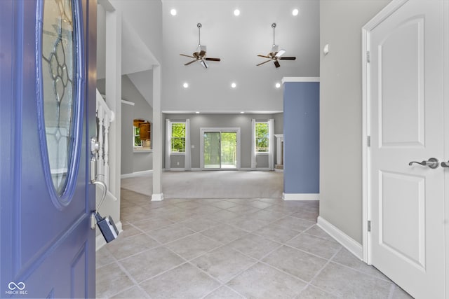 entryway with high vaulted ceiling, a ceiling fan, baseboards, light tile patterned floors, and recessed lighting