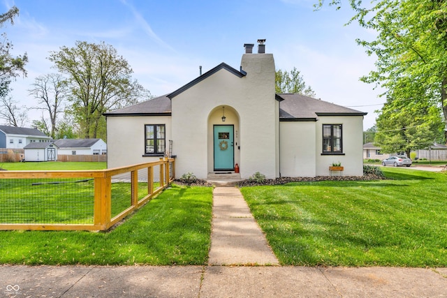 695 W Clinton St, Danville, IN 46122 - view of front facade with stucco siding, a chimney, and a shingled roof