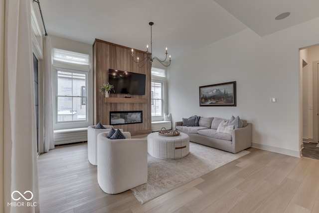 17346 Newton Main St, Westfield, IN 46074 - living room featuring light wood-style flooring, a fireplace, a chandelier, and baseboards