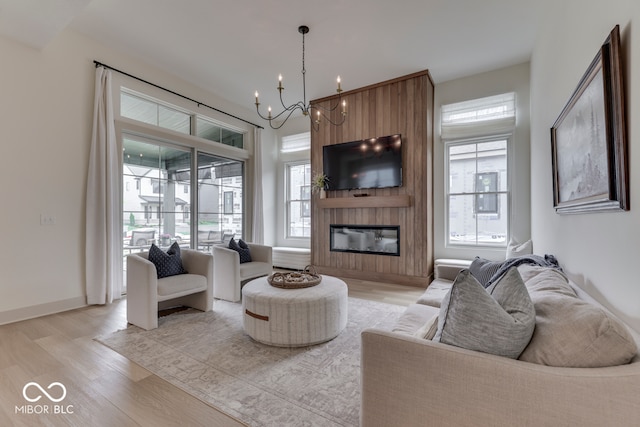 17346 Newton Main St, Westfield, IN 46074 - living room featuring healthy amount of natural light, a chandelier, light wood-style floors, and a fireplace