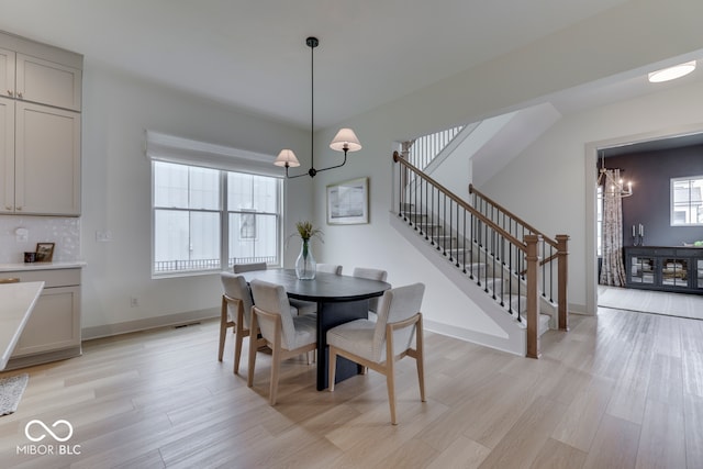 17346 Newton Main St, Westfield, IN 46074 - dining area featuring a chandelier, light wood-type flooring, stairs, and baseboards