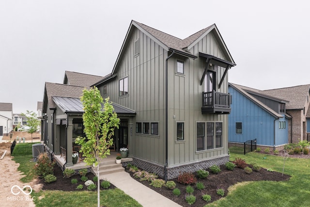 17346 Newton Main St, Westfield, IN 46074 - view of front of home featuring board and batten siding, a balcony, central AC unit, and roof with shingles