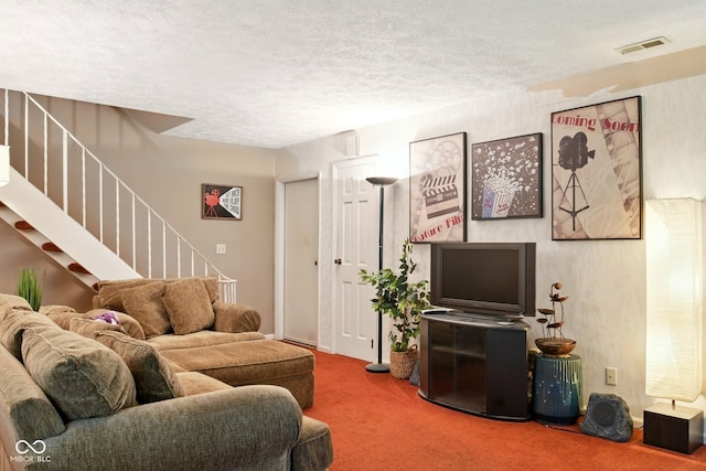 carpeted living room featuring stairway and a textured ceiling