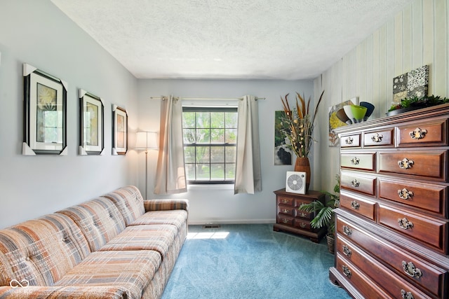 living area featuring carpet floors, a textured ceiling, and baseboards