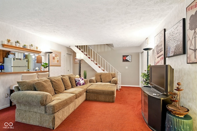 carpeted living area with stairs and a textured ceiling