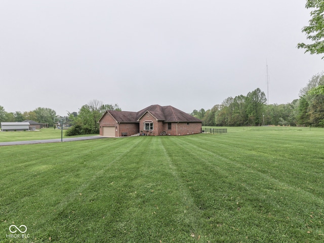 ranch-style home with asphalt driveway, an attached garage, a front yard, and brick siding