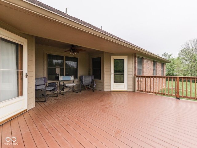 wooden deck featuring ceiling fan