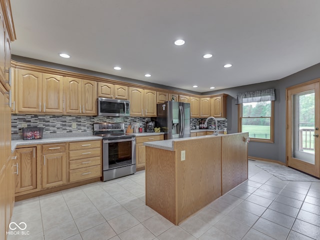 kitchen featuring appliances with stainless steel finishes, light tile patterned floors, decorative backsplash, light countertops, and recessed lighting