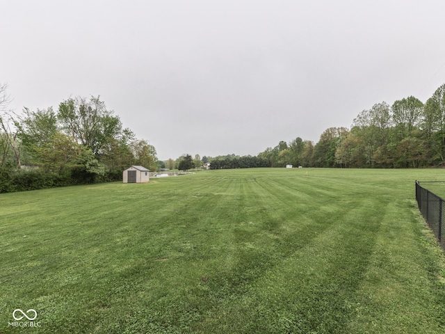 view of yard featuring a storage unit and an outbuilding