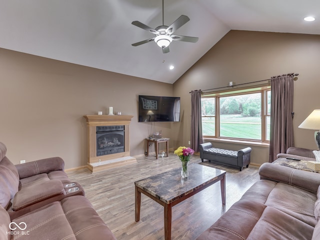 living area with ceiling fan, wood finished floors, high vaulted ceiling, recessed lighting, and baseboards