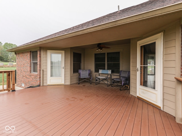 wooden terrace featuring ceiling fan