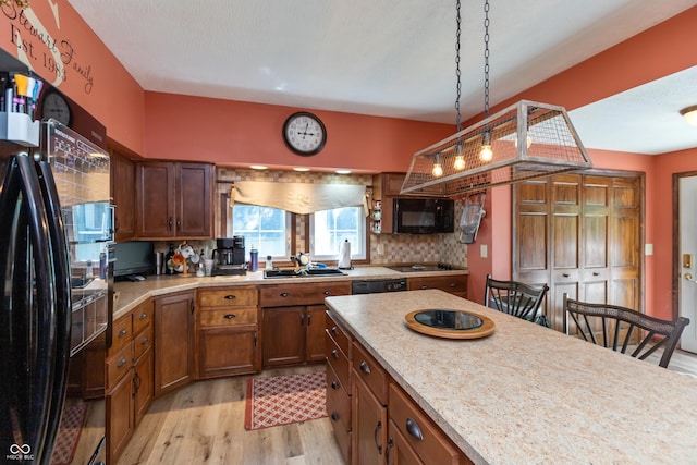 455 E Main St, Danville, IN 46122 - kitchen with black appliances, a sink, light wood-style flooring, light countertops, and brown cabinetry