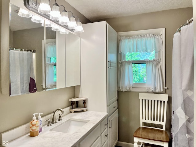 bathroom featuring vanity and a textured ceiling