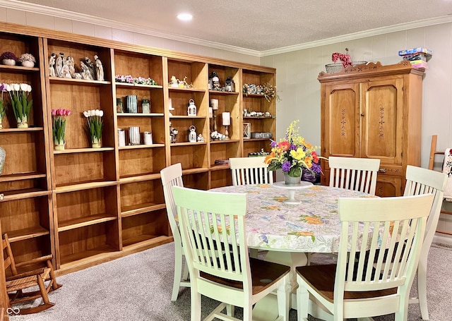 carpeted dining area featuring crown molding