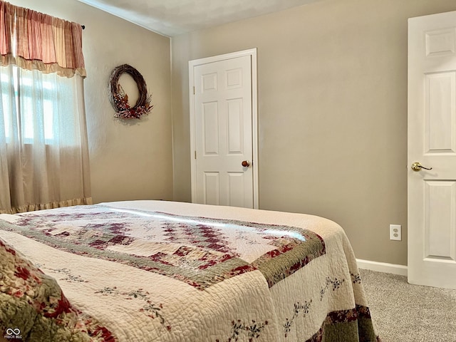 carpeted bedroom with baseboards