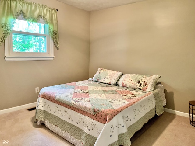 bedroom featuring carpet and baseboards