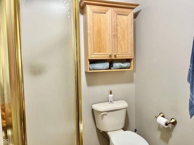 full bathroom featuring toilet and an enclosed shower