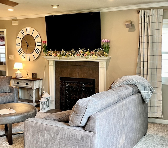carpeted living room with ornamental molding, a tile fireplace, and recessed lighting