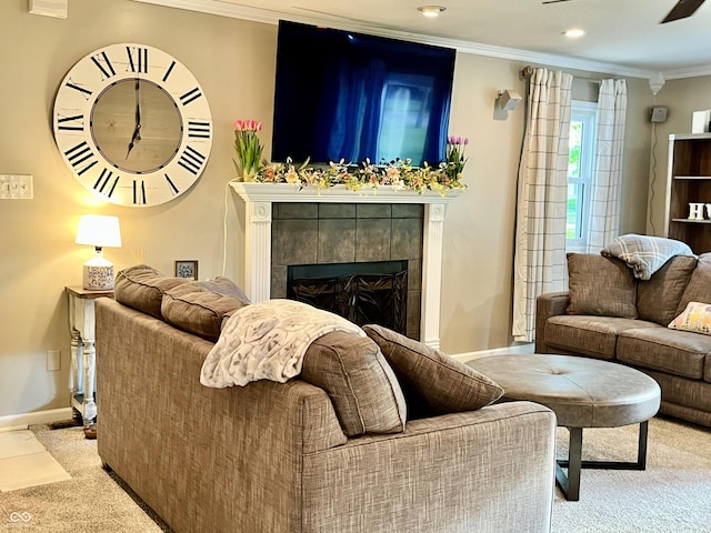 living area featuring a fireplace, carpet floors, crown molding, baseboards, and a ceiling fan