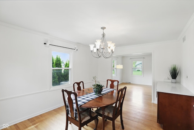 6825 Farmleigh Dr, Indianapolis, IN 46220 - dining area with a chandelier, light wood-style floors, ornamental molding, and baseboards