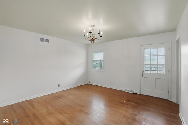 6825 Farmleigh Dr, Indianapolis, IN 46220 - unfurnished dining area featuring a chandelier, wood finished floors, and baseboards