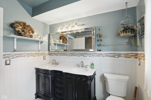 6825 Farmleigh Dr, Indianapolis, IN 46220 - bathroom with a wainscoted wall, toilet, and double vanity