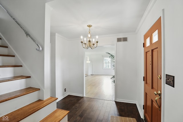 6825 Farmleigh Dr, Indianapolis, IN 46220 - entrance foyer with stairs, a chandelier, dark wood-style flooring, crown molding, and baseboards
