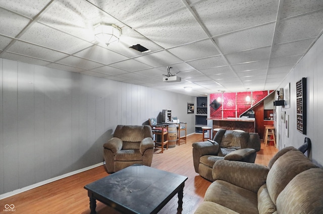 6825 Farmleigh Dr, Indianapolis, IN 46220 - living room with wood finished floors, a paneled ceiling, baseboards, and bar area