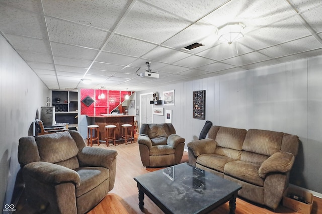 6825 Farmleigh Dr, Indianapolis, IN 46220 - living room featuring a dry bar, wood finished floors, built in shelves, and a drop ceiling