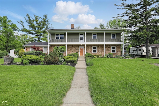 6825 Farmleigh Dr, Indianapolis, IN 46220 - view of property with a chimney, a front yard, brick siding, and a balcony