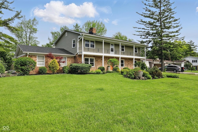 6825 Farmleigh Dr, Indianapolis, IN 46220 - view of front of property featuring a chimney, a front yard, and brick siding