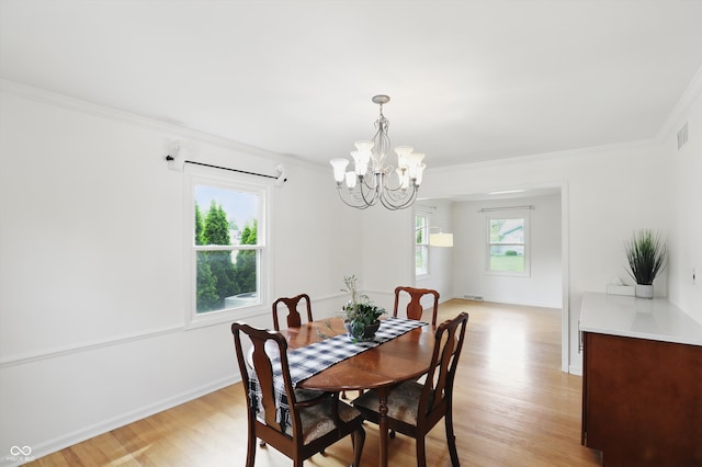 6825 Farmleigh Dr, Indianapolis, IN 46220 - dining room with a chandelier, light wood finished floors, ornamental molding, and baseboards