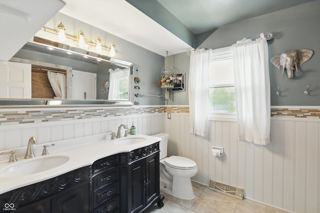 6825 Farmleigh Dr, Indianapolis, IN 46220 - full bath with toilet, wainscoting, tile patterned flooring, and double vanity