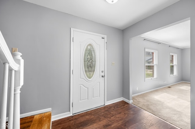 entrance foyer featuring baseboards and wood finished floors