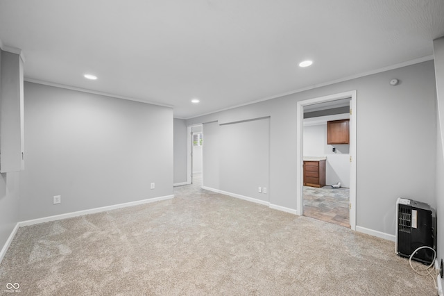 basement with carpet flooring, recessed lighting, ornamental molding, baseboards, and heating unit