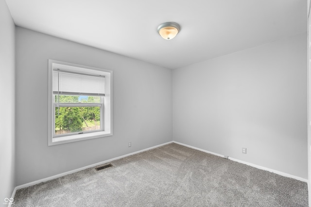 carpeted empty room with baseboards