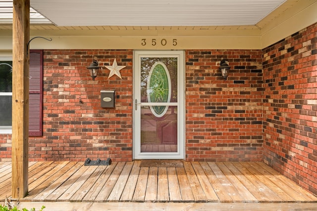 view of exterior entry with brick siding