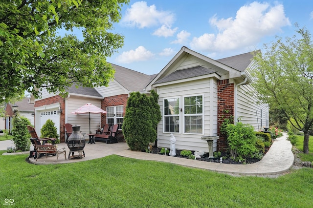 1663 Sweetgum Dr, Greenwood, IN 46143 - back of house featuring a patio area, a lawn, brick siding, a fire pit, and a shingled roof