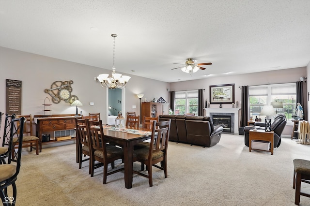 1663 Sweetgum Dr, Greenwood, IN 46143 - dining space with light colored carpet, a ceiling fan, a glass covered fireplace, a chandelier, and a textured ceiling
