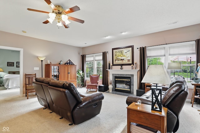 1663 Sweetgum Dr, Greenwood, IN 46143 - living room featuring light carpet, a ceiling fan, and a high end fireplace