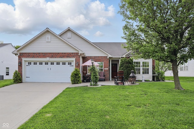 1663 Sweetgum Dr, Greenwood, IN 46143 - view of front of house with brick siding, a garage, concrete driveway, and a front lawn